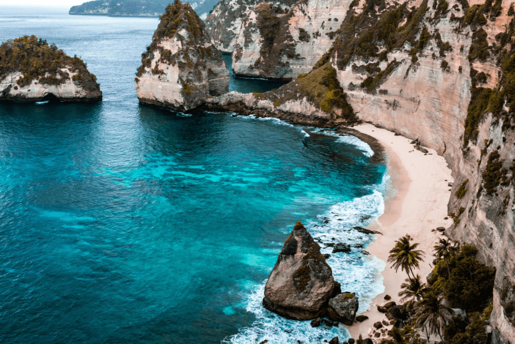 A secluded white sand beach with turquoise waters in Bali.