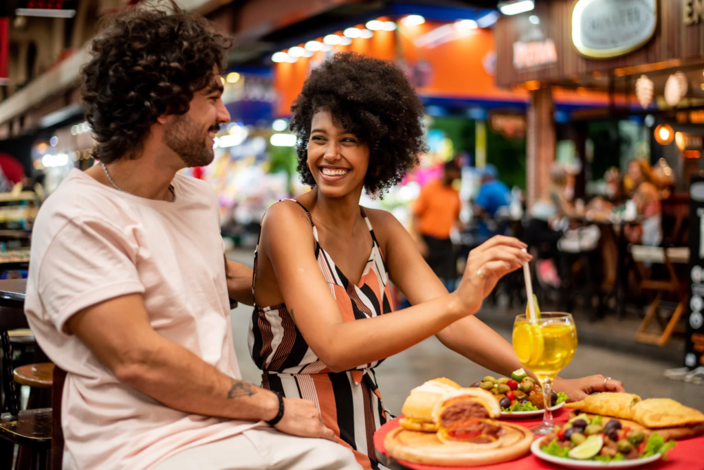 Backpackers enjoying street food in Brazil.