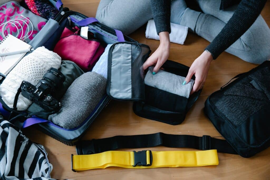 A traveler packing a backpack for a Brazil trip.