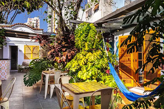 Travelers enjoying the rooftop bar at O de Casa Hostel Bar in São Paulo.